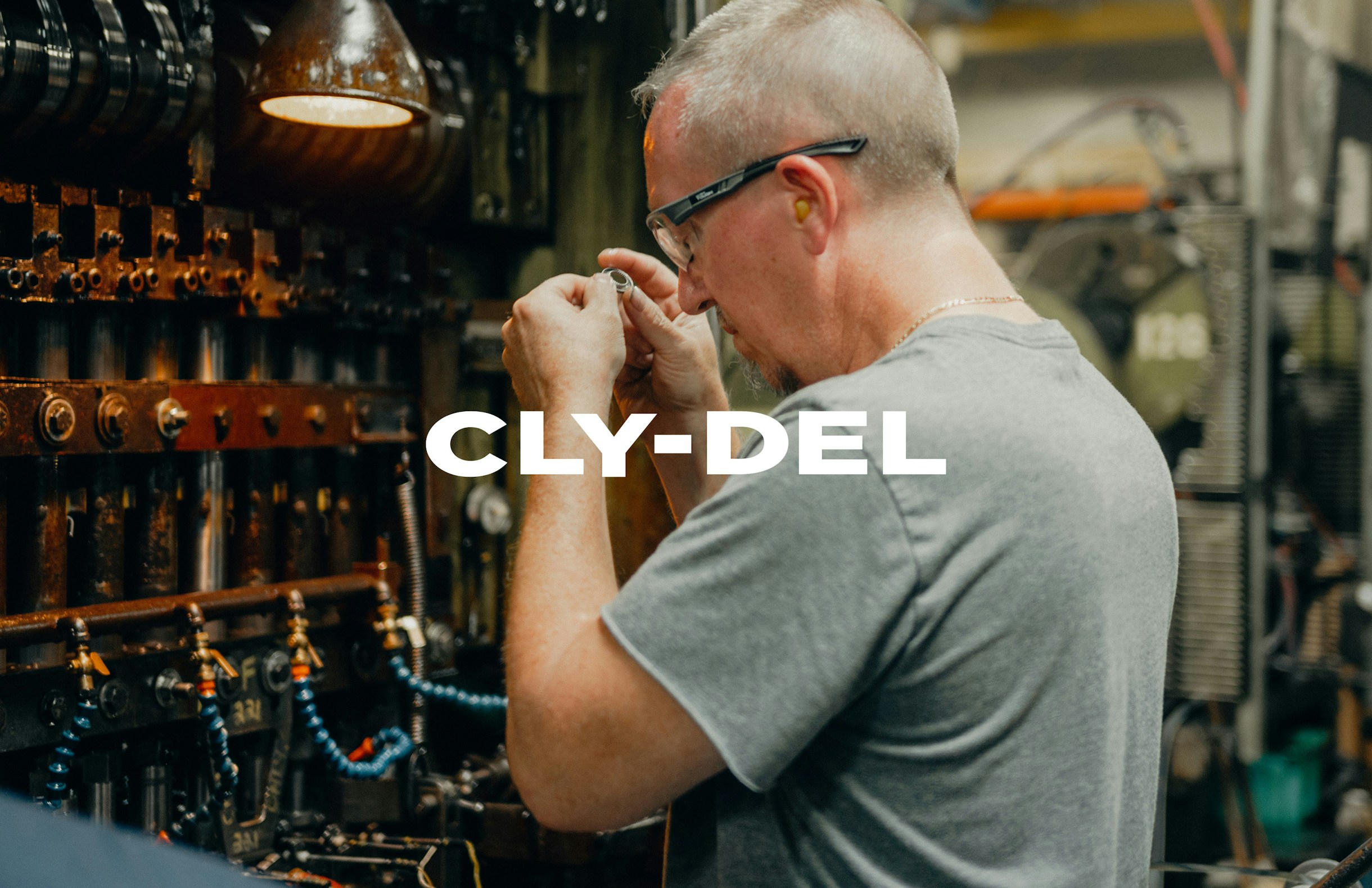 Worker operating machinery inside the Cly-Del manufacturing plant.