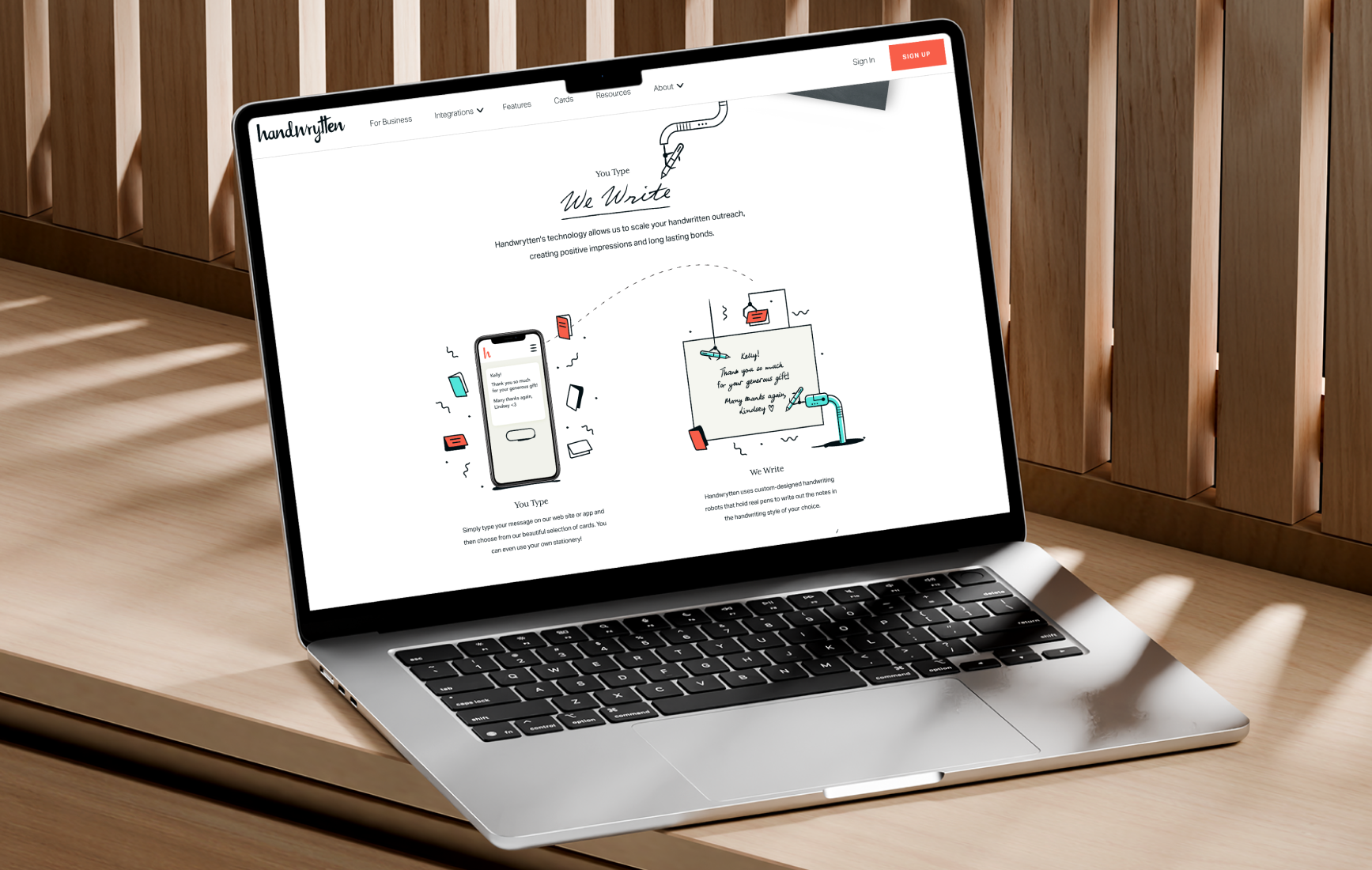 Laptop displaying a clean website layout with illustrations and product cards.