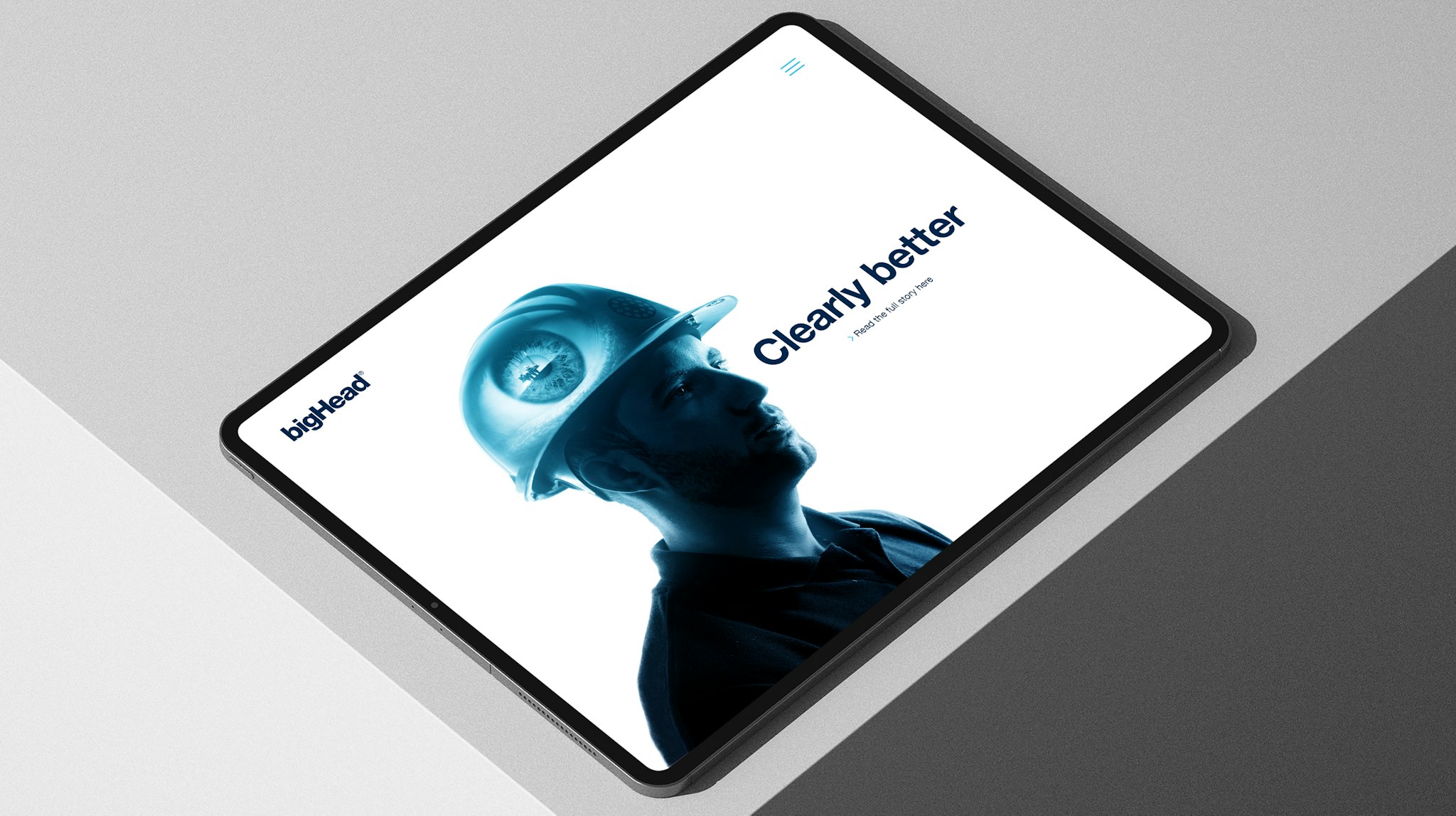 bigHead website on tablet screen showing worker in hard hat with message ‘Clearly better’