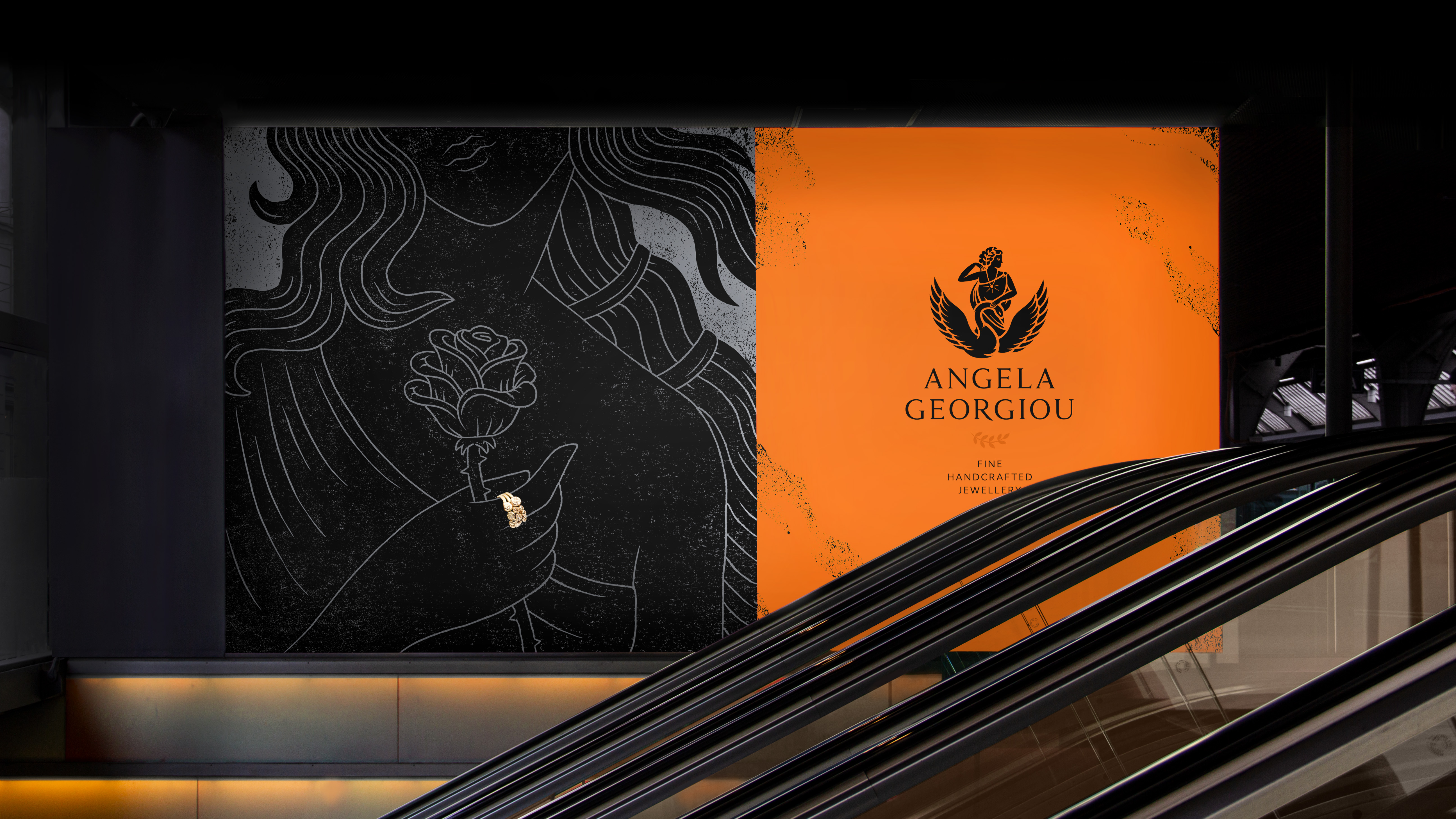 Luxury billboard in shopping mall showing black & grey Greek goddess illustration with gold ring, Angela Georgiou logo and strapline on bronze