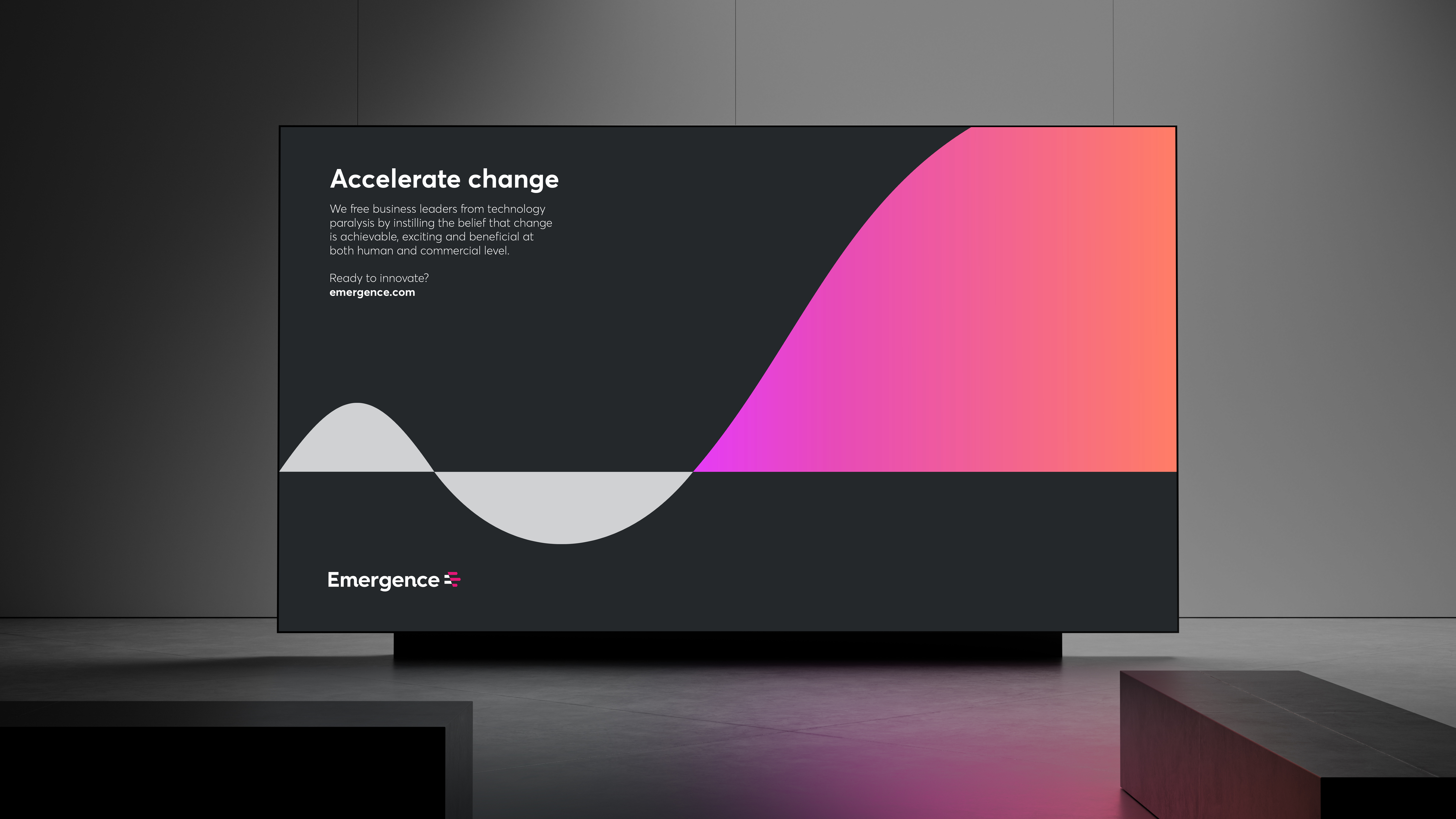 Digital screen in event space showing Emergence 'Accelerate Change' message with abstract grey and pink graphic suggesting transformation