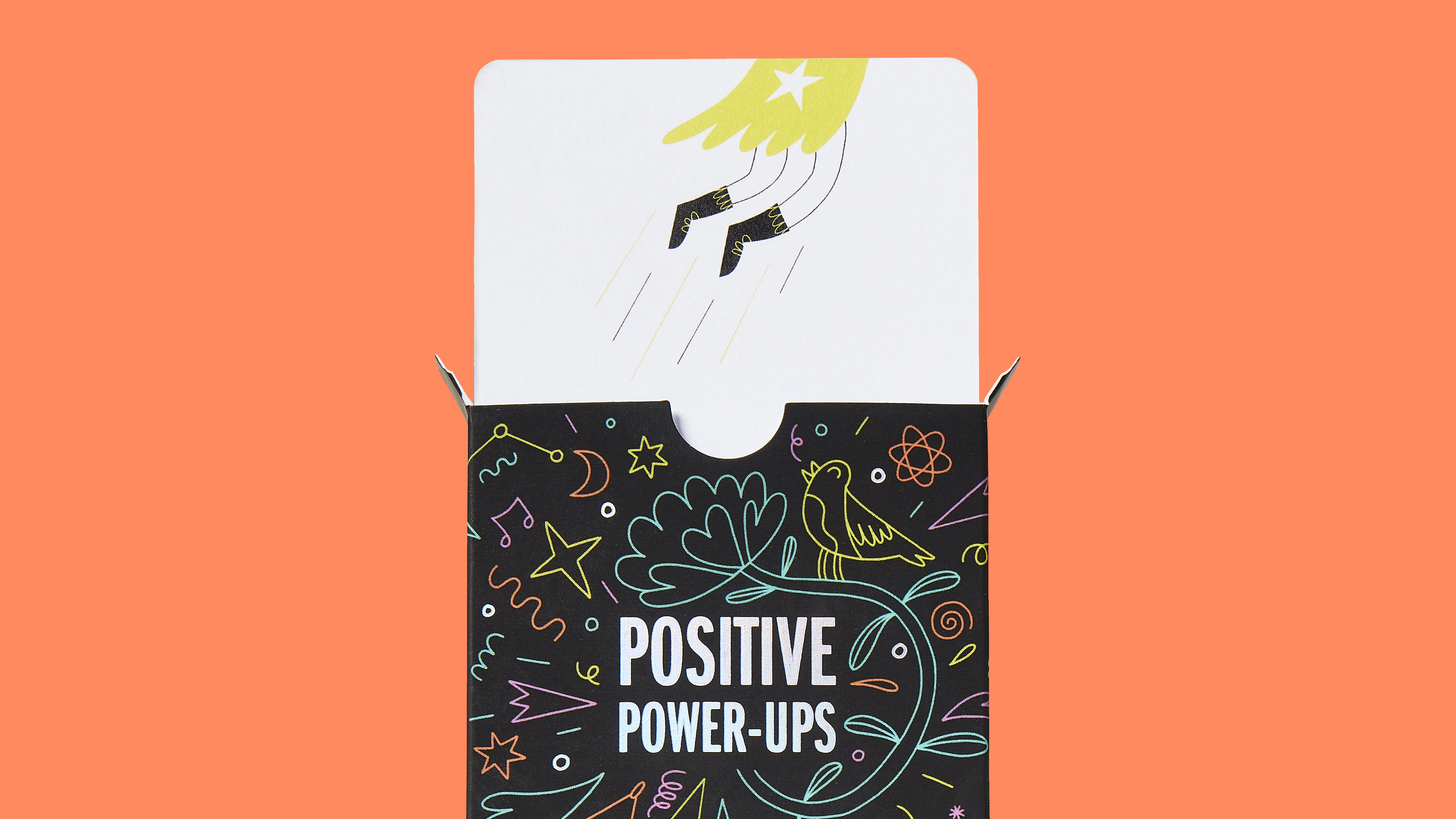Positive Power-Ups card emerging from box with flying hero illustration and detailed packaging graphics on orange background
