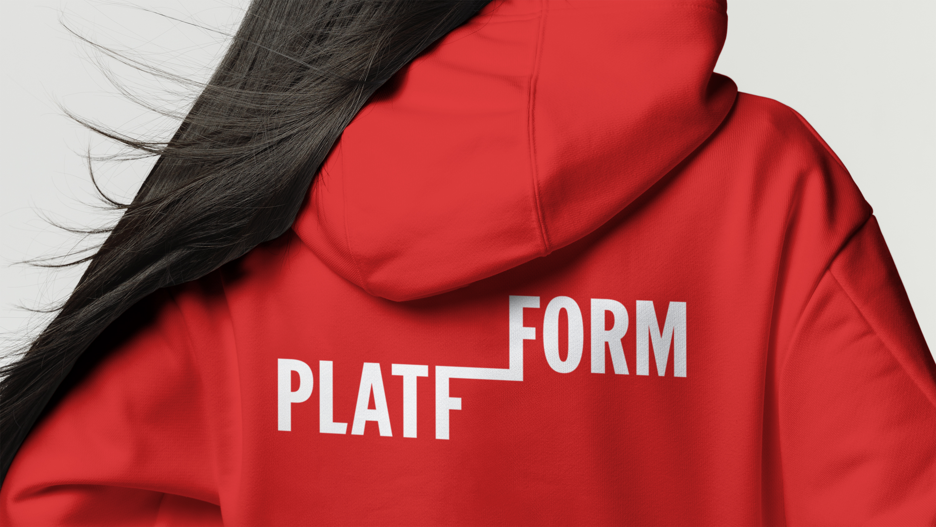 Back view of person wearing a red hoodie with a bold white 'PLATFFORM' logo