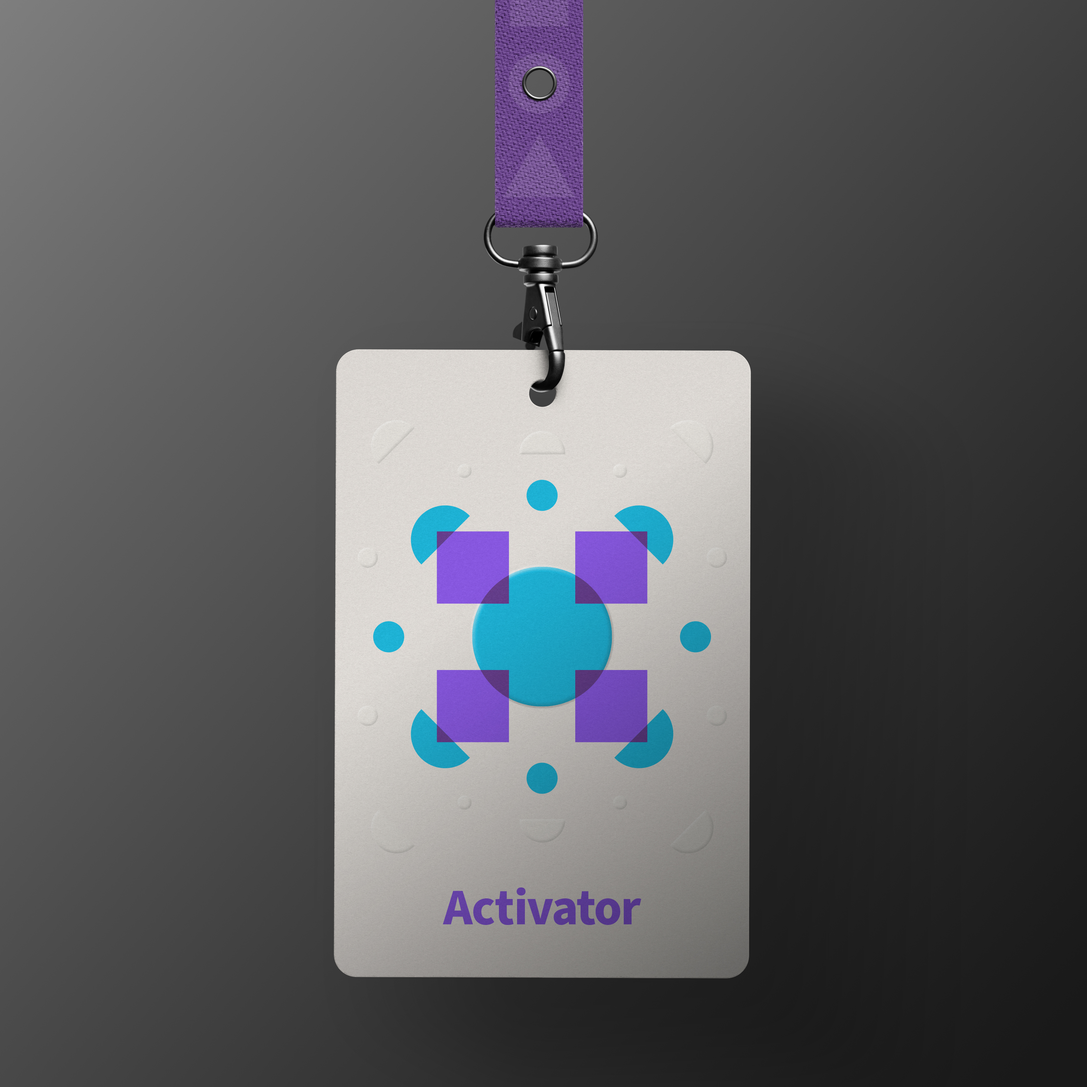 Cream badge with abstract burst of purple and blue shapes with the word "Activator" below, and dark purple lanyard, hanging in dark grey background