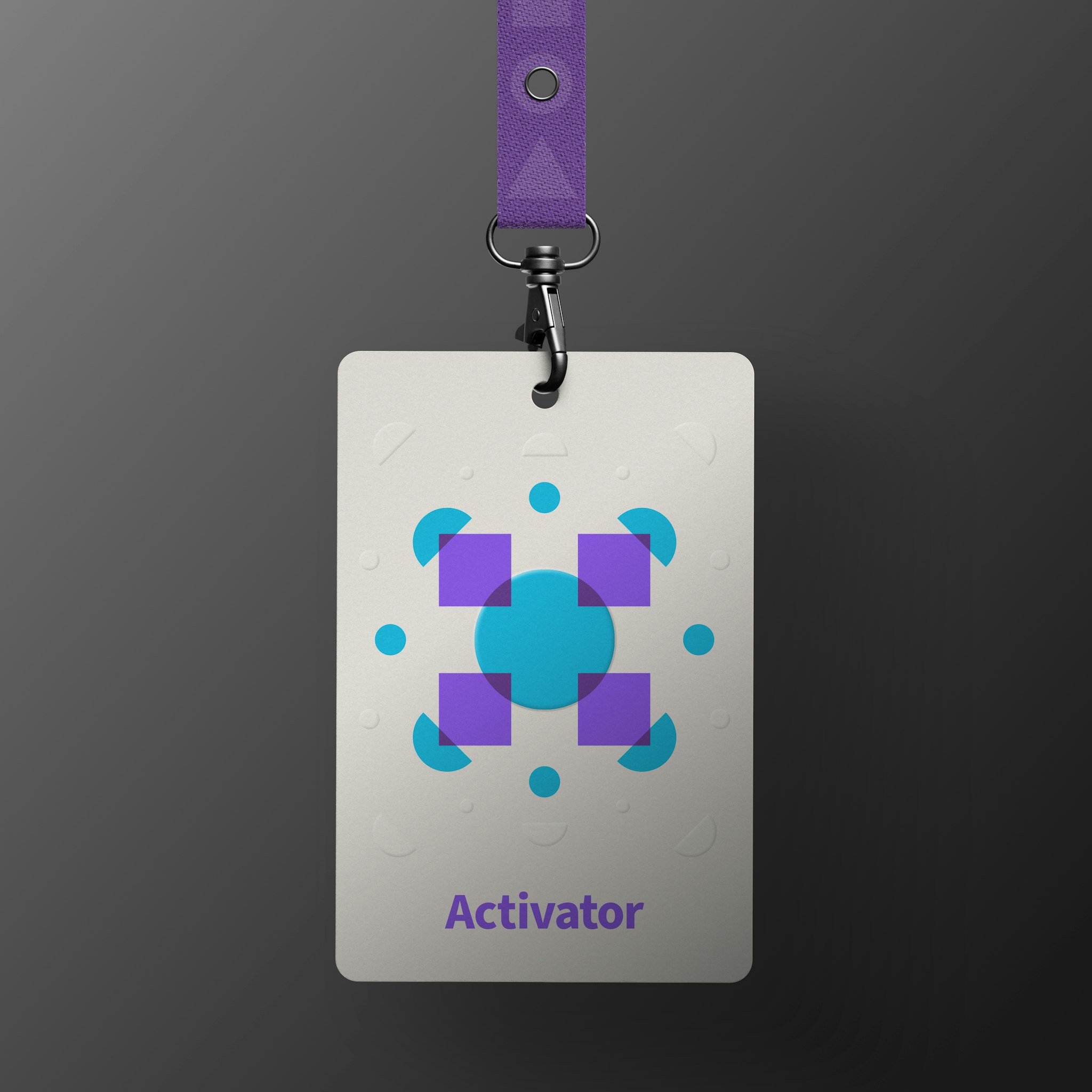 Cream badge with abstract burst of purple and blue shapes with the word "Activator" below, and dark purple lanyard, hanging in dark grey background