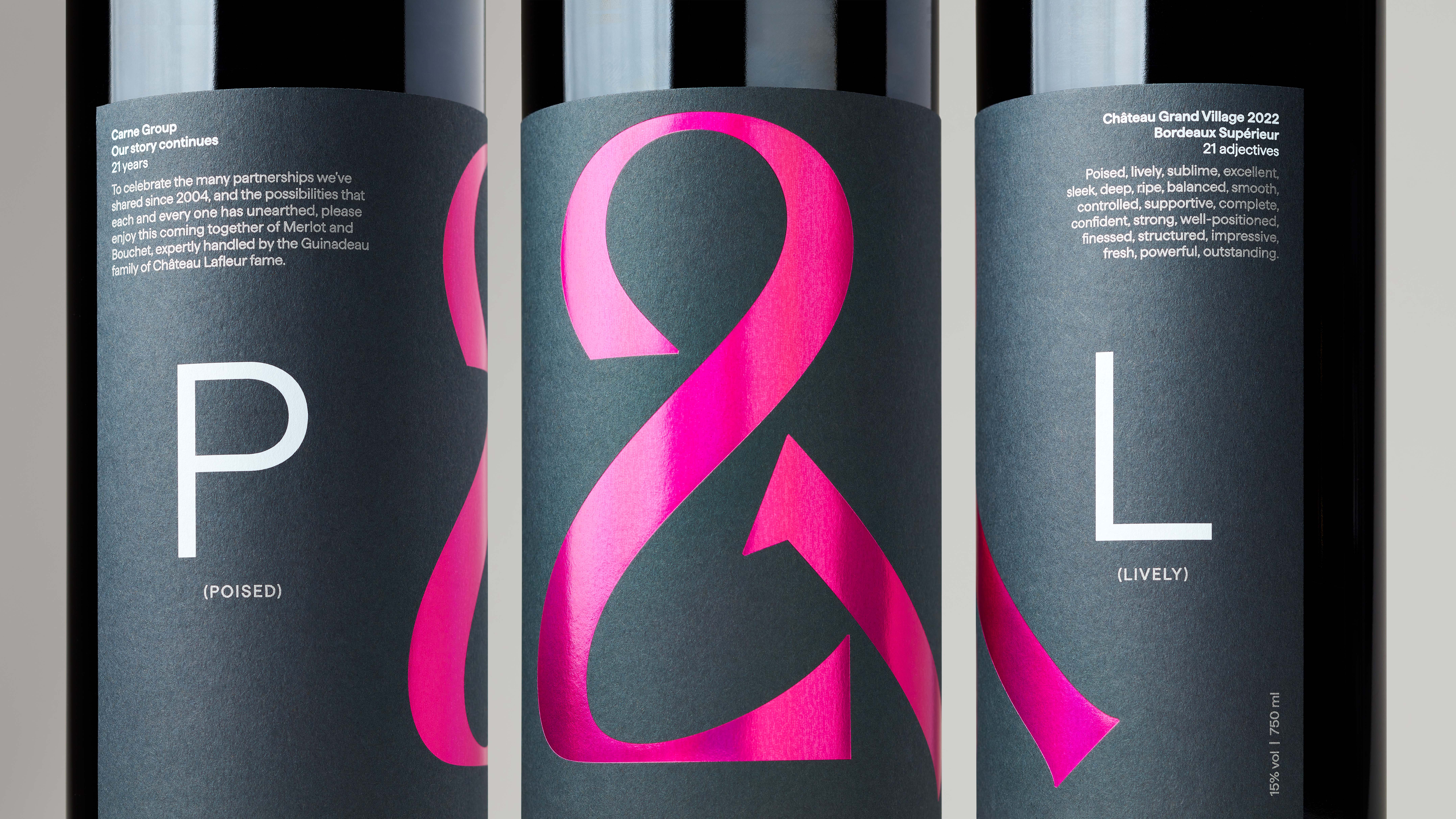 Close-up of three red wine bottles with P&L label featuring hot pink holographic ampersand and white text on dark grey