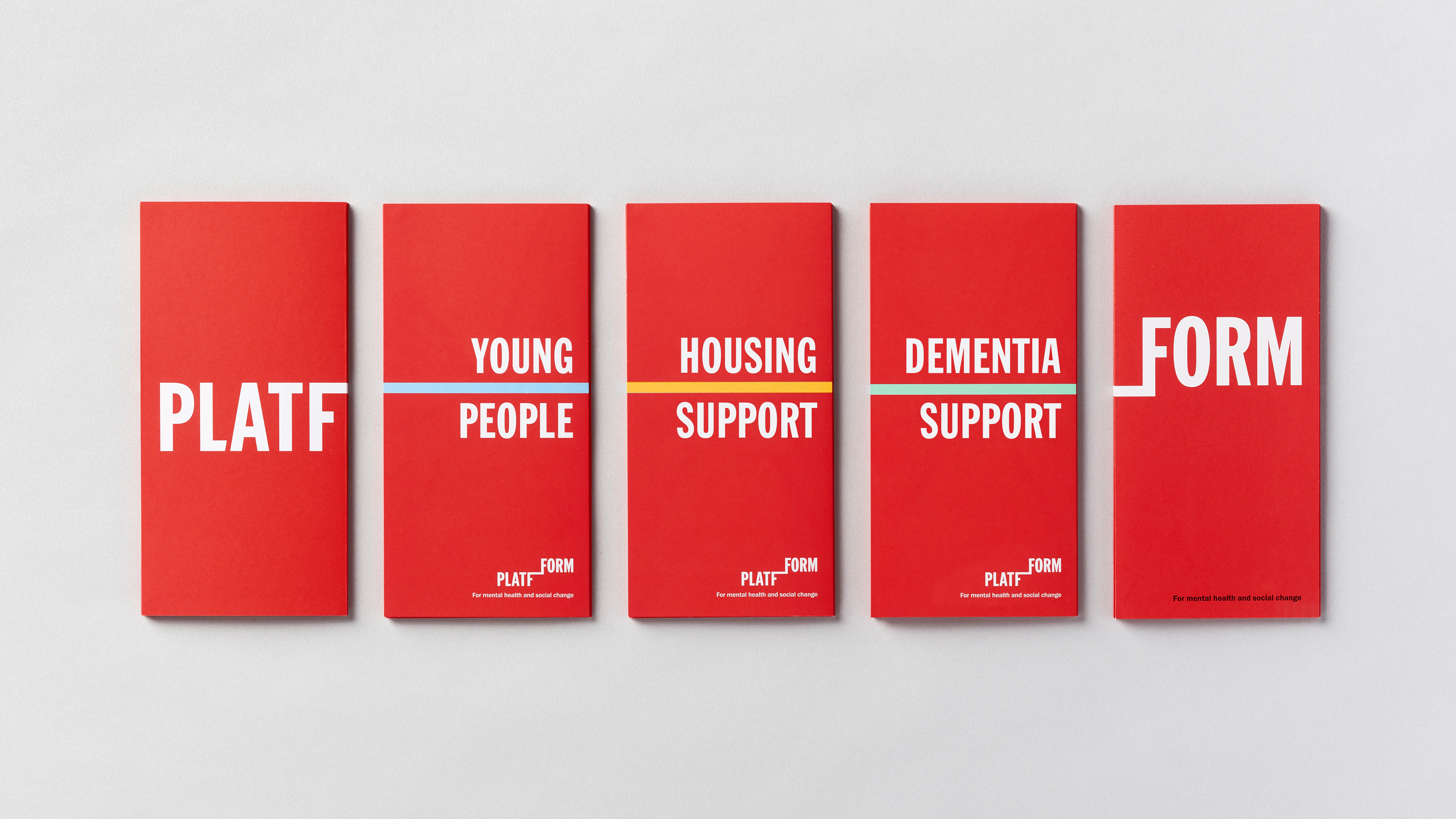 Line-up of red Platfform brochures on the different communities they support on light grey background