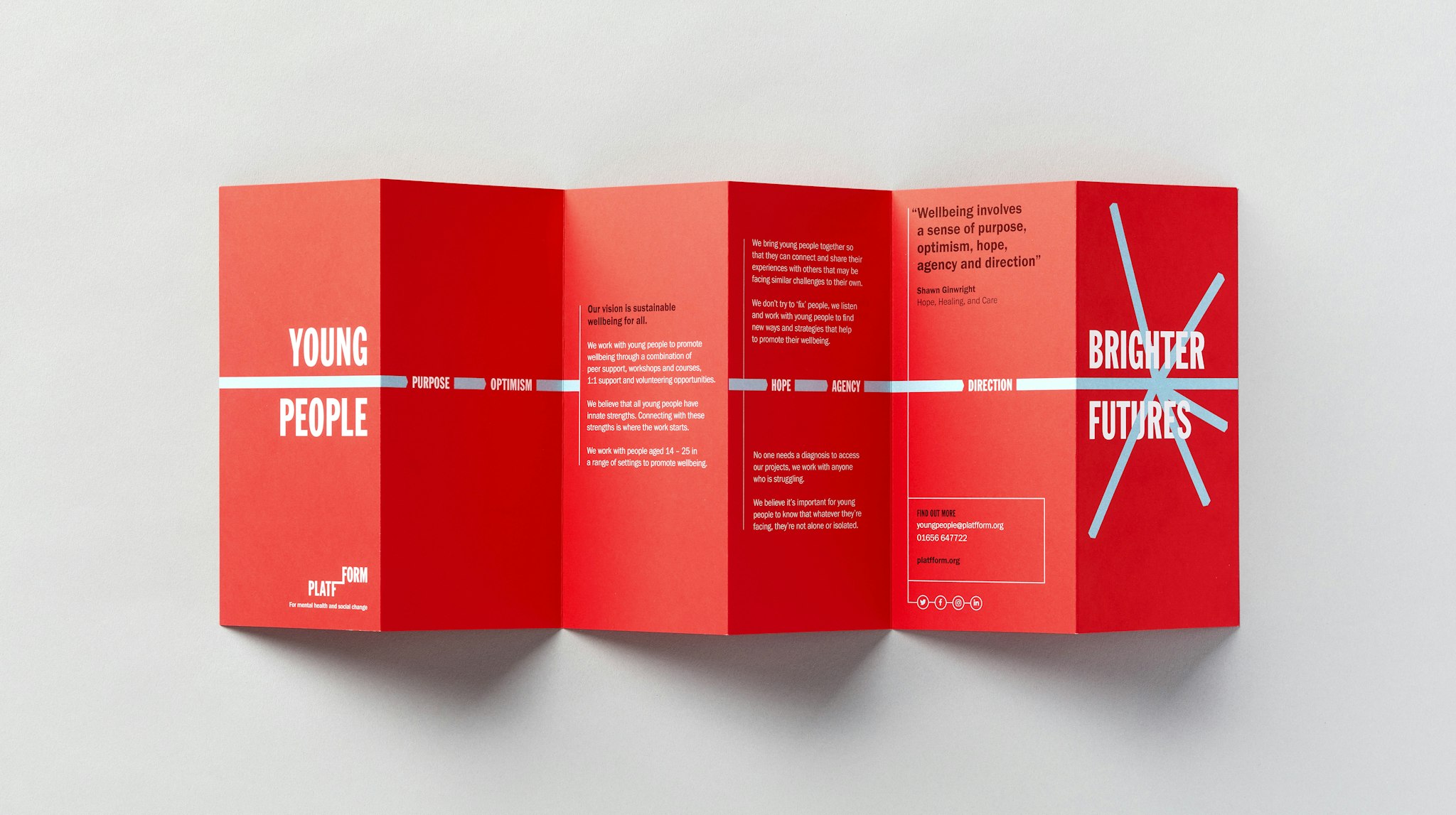 Unfolded red Platfform brochure on light grey surface showing how the charity helps young people reach brighter futures