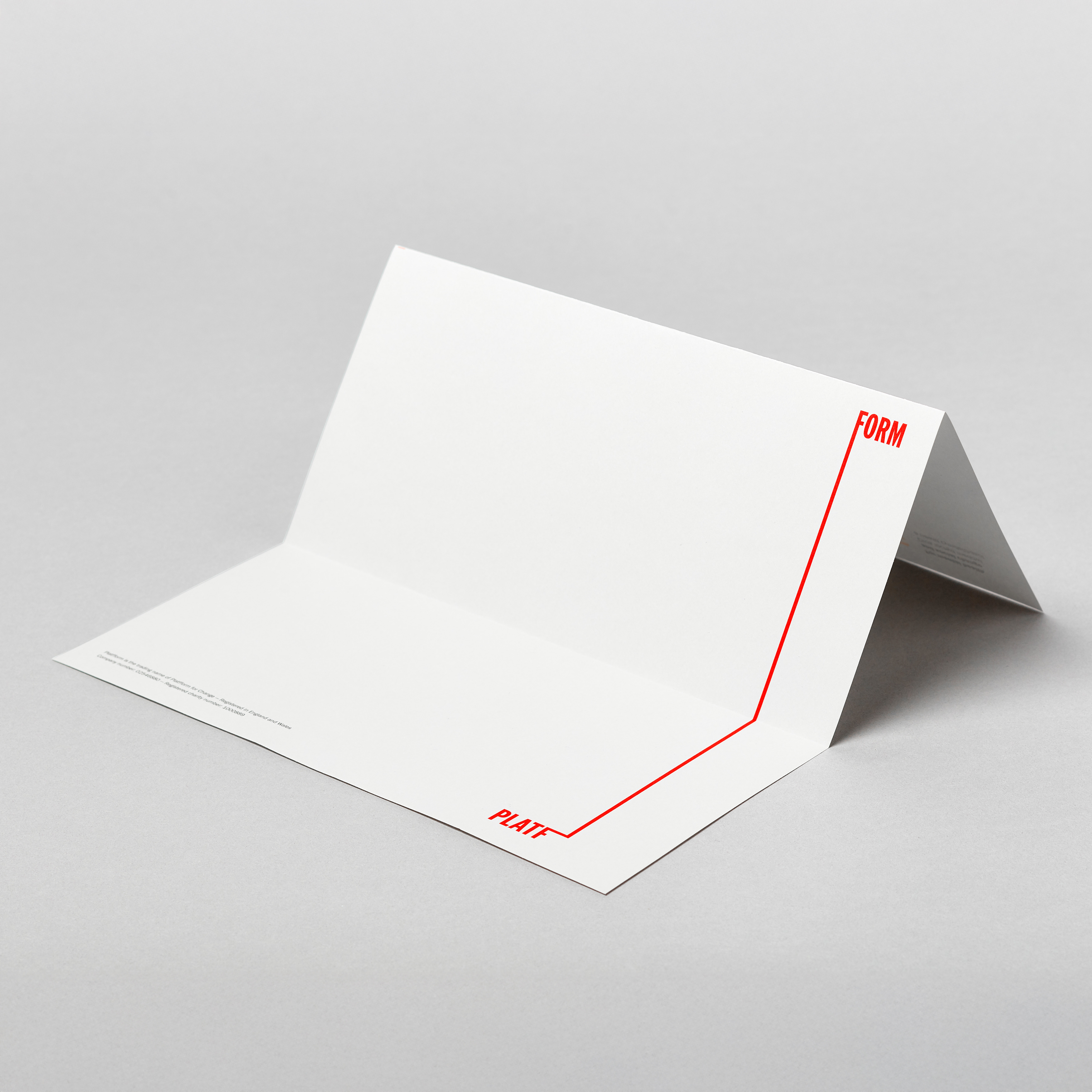 Folded white letterhead with red stretched Platfform logo on light grey background