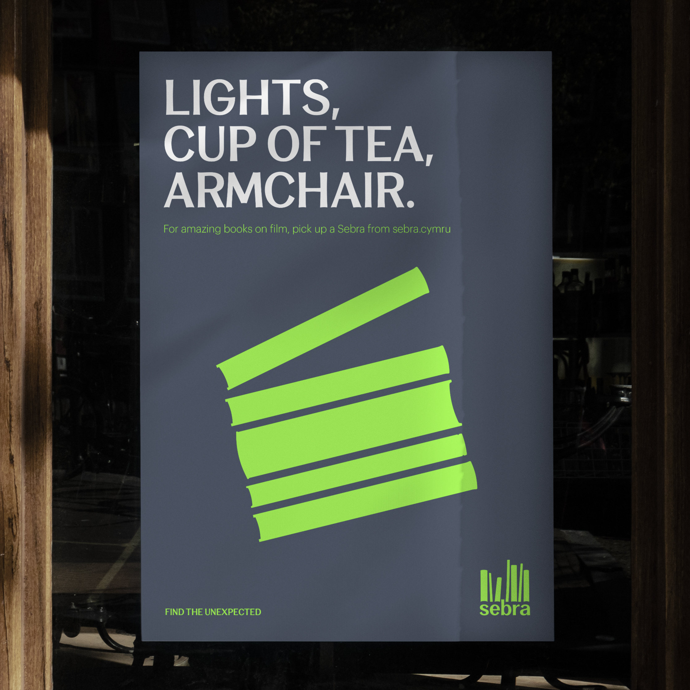 Sebra poster with bold text ‘Lights, Cup of Tea, Armchair’ and green stacked book graphics forming a film clapper board.