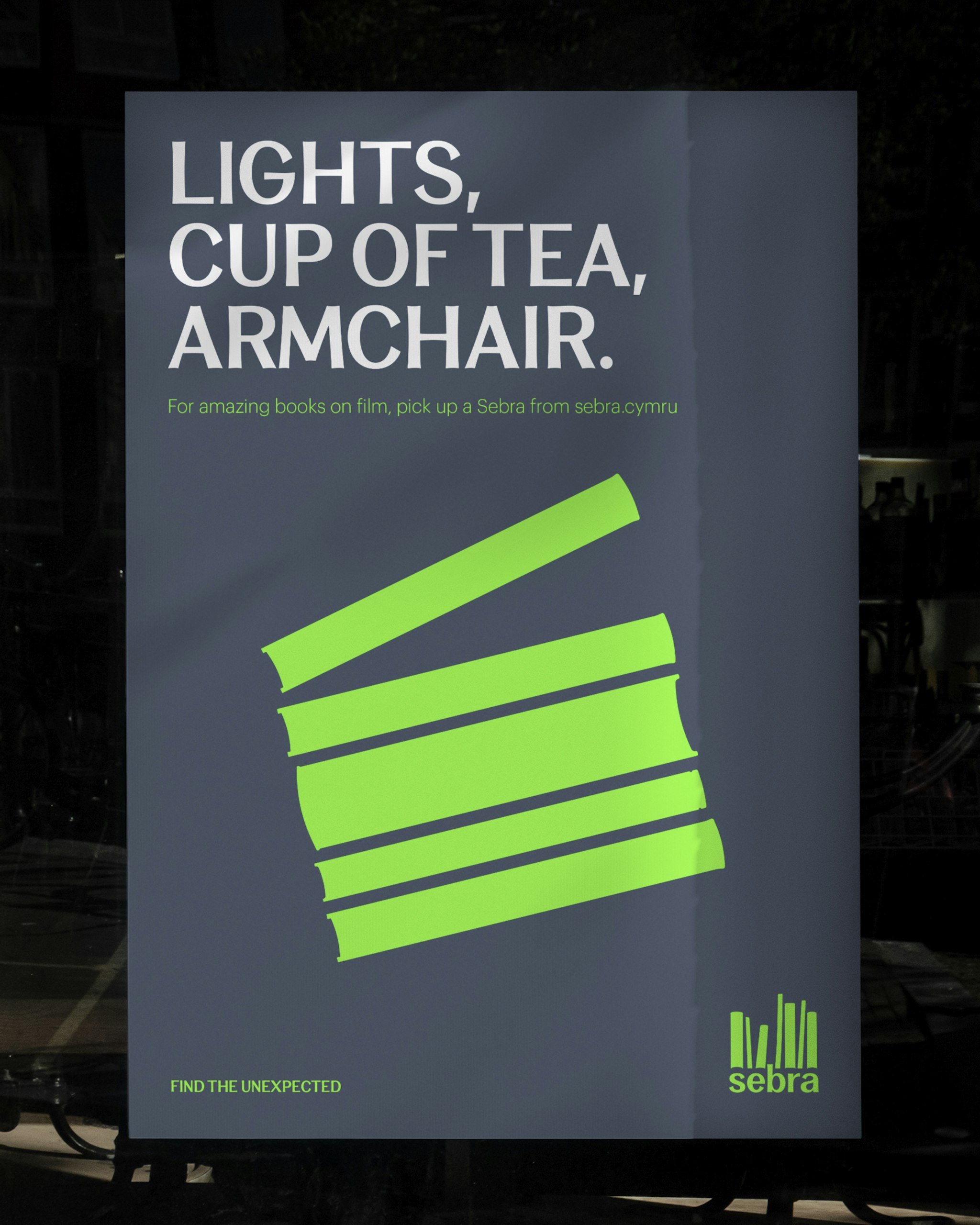 Sebra poster with bold text ‘Lights, Cup of Tea, Armchair’ and green stacked book graphics forming a film clapper board.