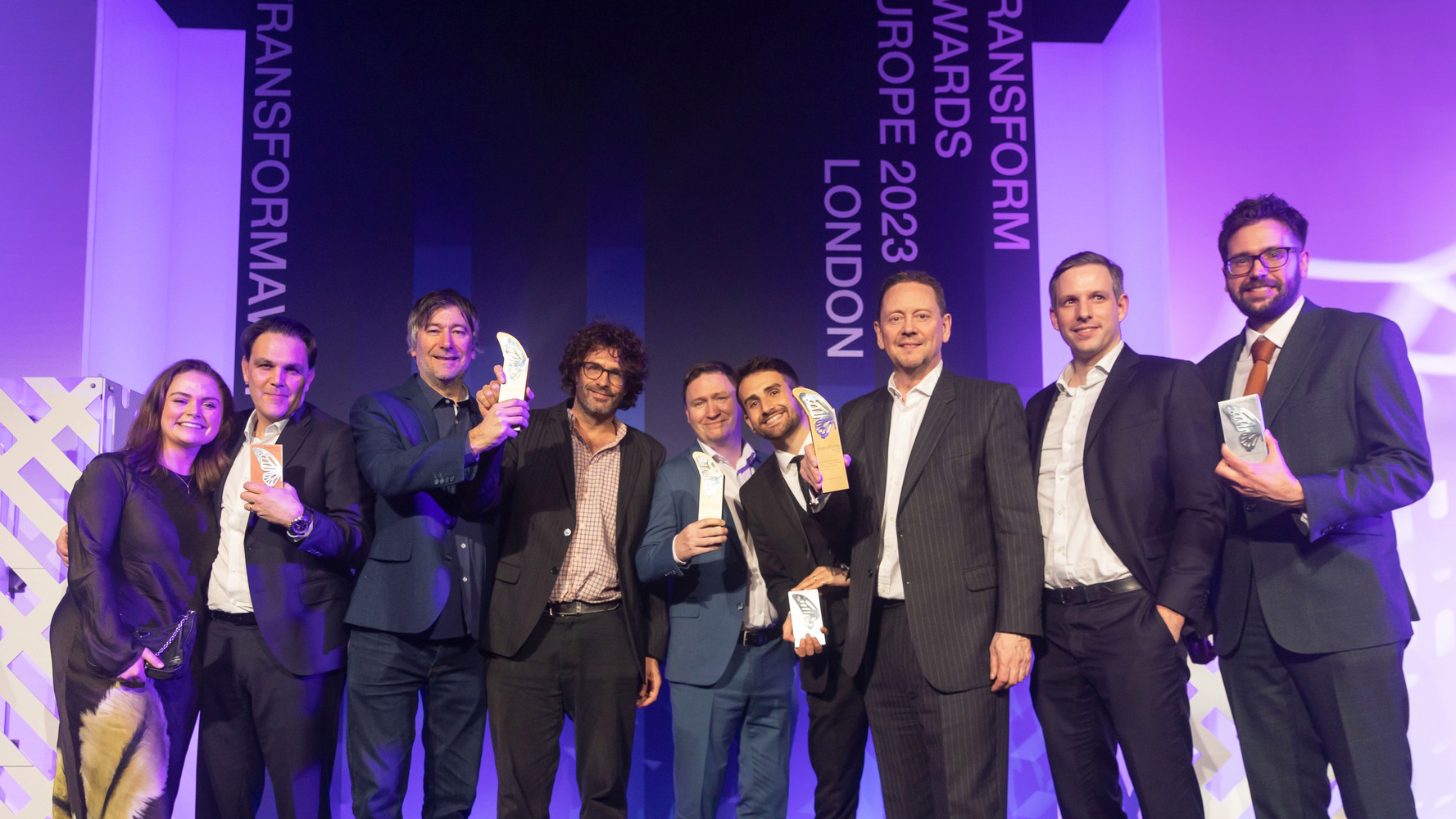 Award-winning branding and design team with client celebrating success at the Transform Awards Europe 2023 in London