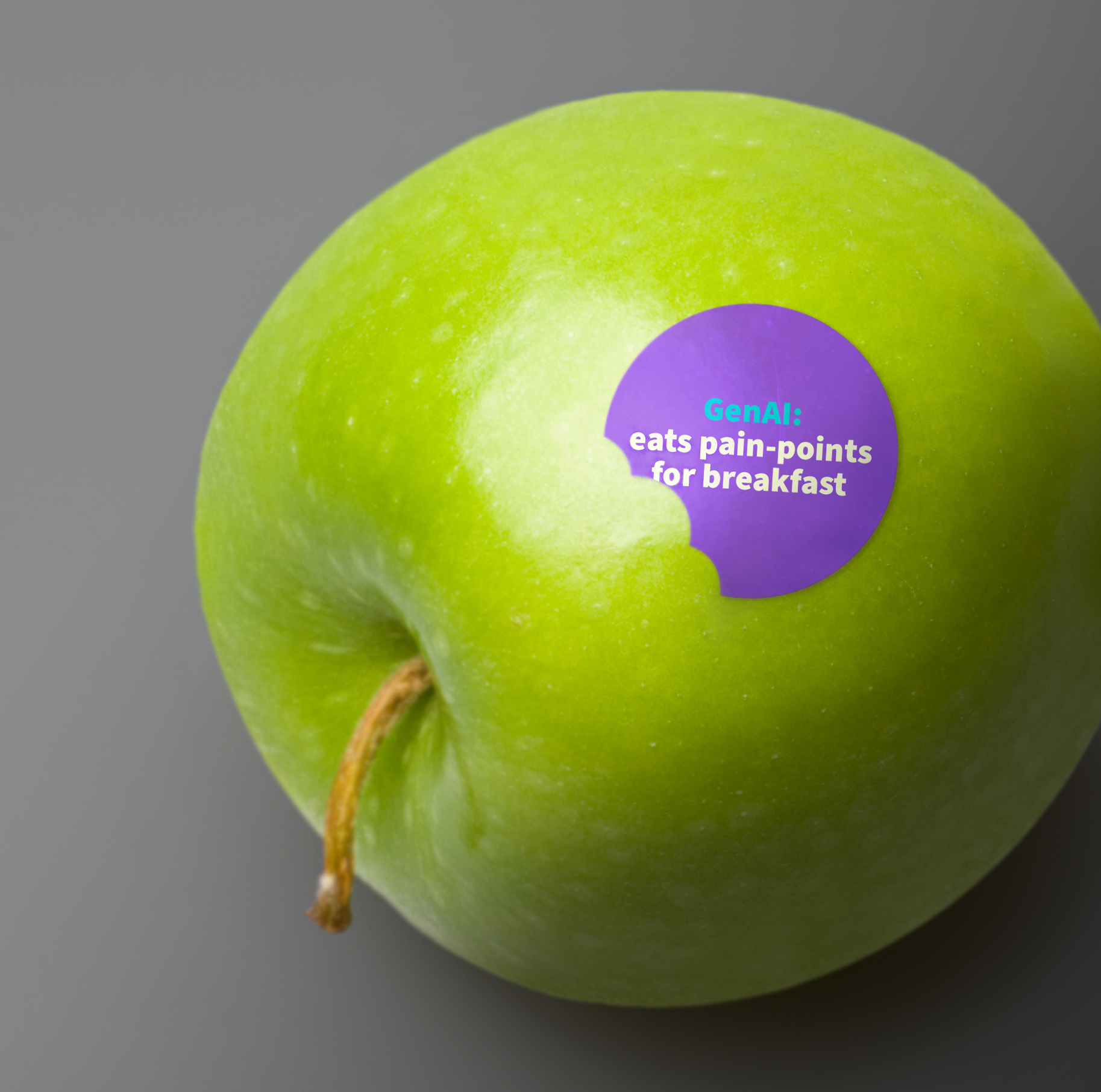 Green apple on grey background with round purple sticker with message about GenAI