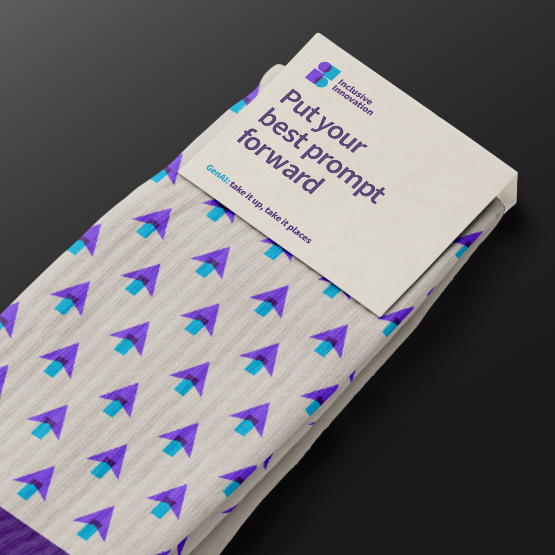 Cream socks with pattern of purple and blue arrows and packaging that says "Put your best prompt forward" with IAG branding on dark grey background