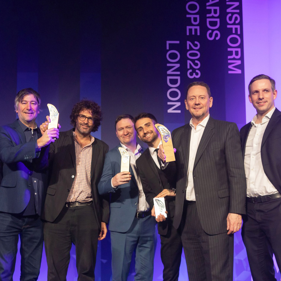 Clout Branding and Carne Group team celebrating on stage at the Transform Awards 2023