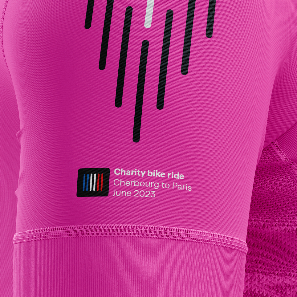 Close-up of bright pink cycling jersey sleeve for Carne Group's Velocity event with graphic lines and event details
