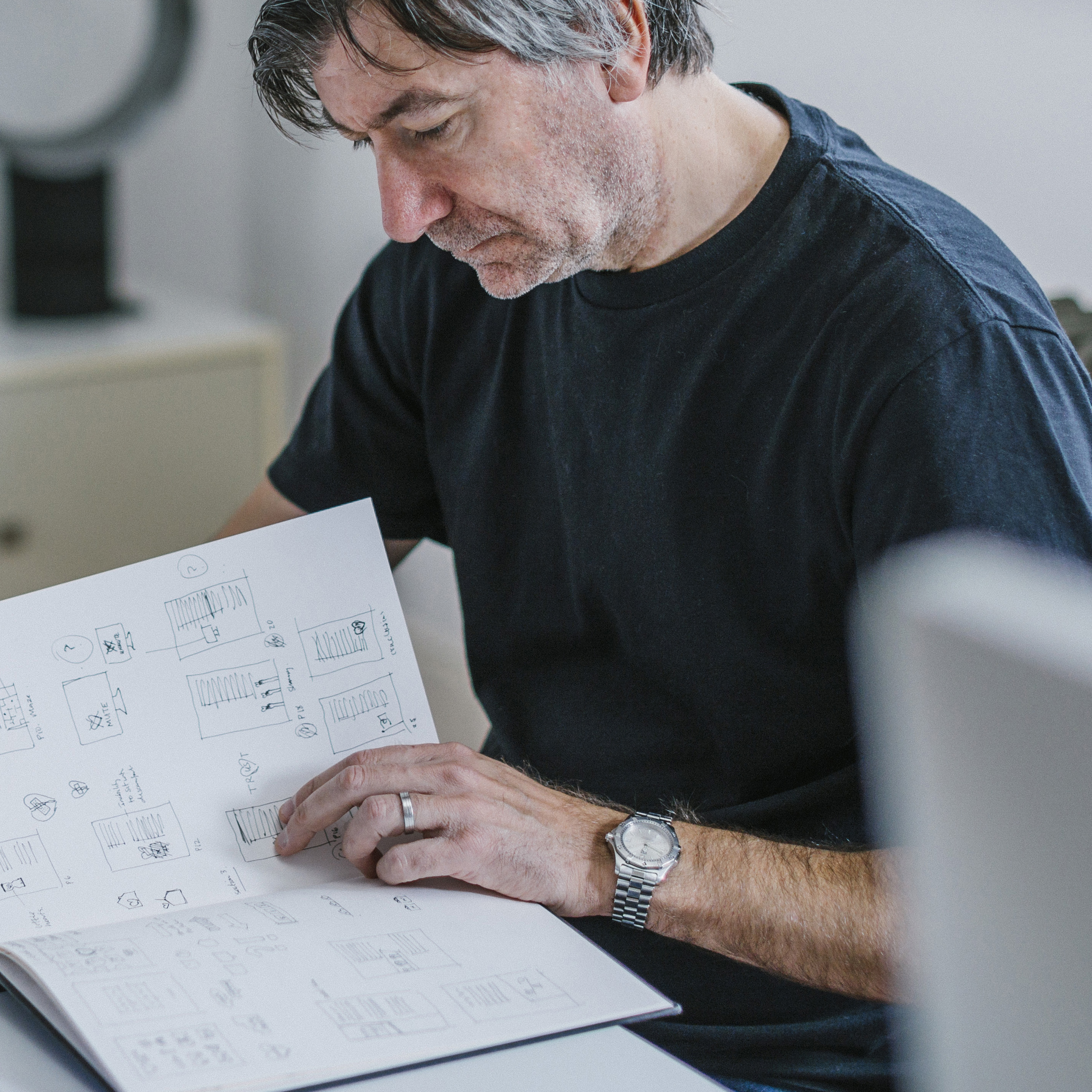 Creative director reviewing sketches for creative project in modern design studio