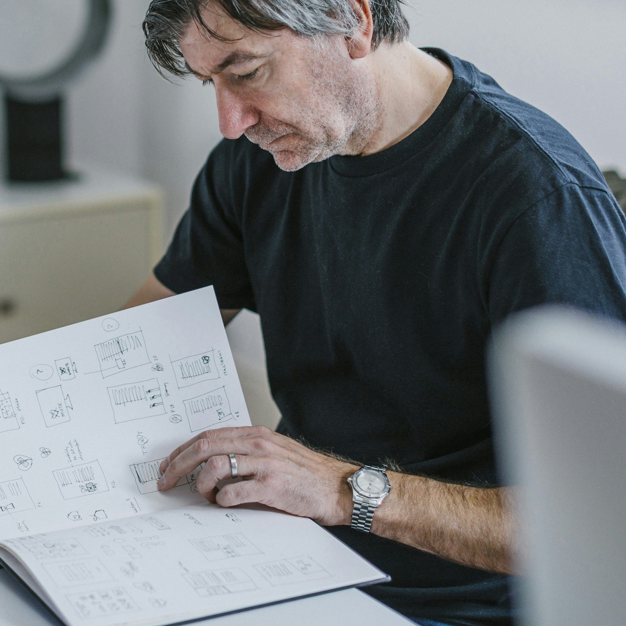 Creative director reviewing sketches for creative project in modern design studio