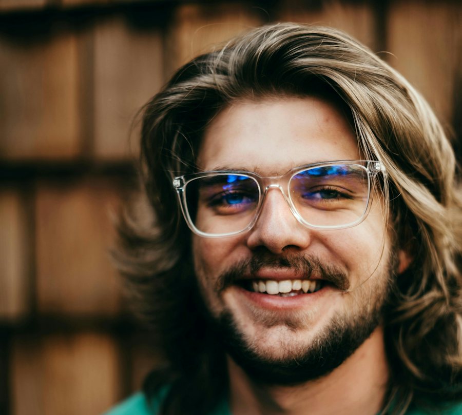 Man with long hair wearing rectangle clear glasses