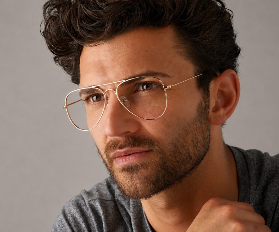 Man wearing a gold metal aviator frame