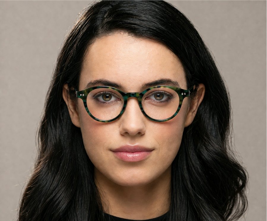 Woman wearing a multi coloured round glasses frame
