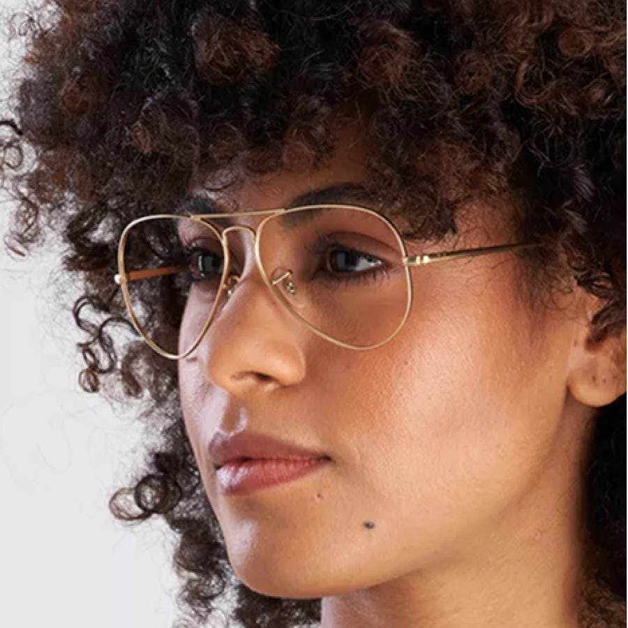Woman wearing a gold aviator glasses frame