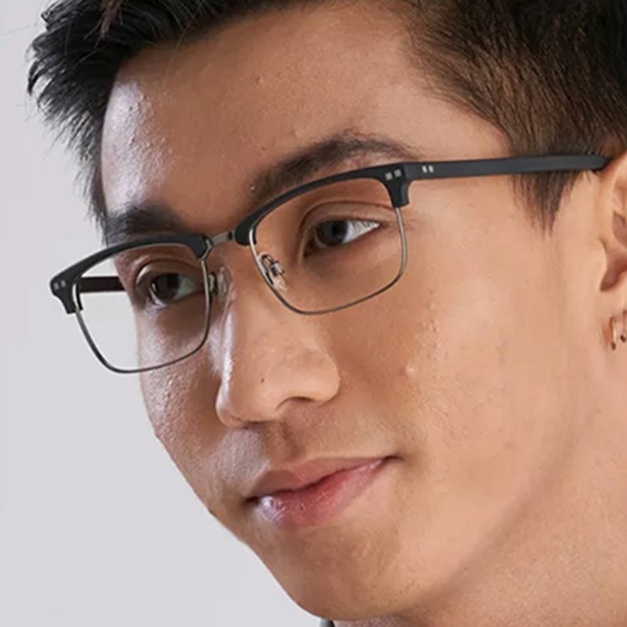 Man wearing a browline black and silver glasses frame