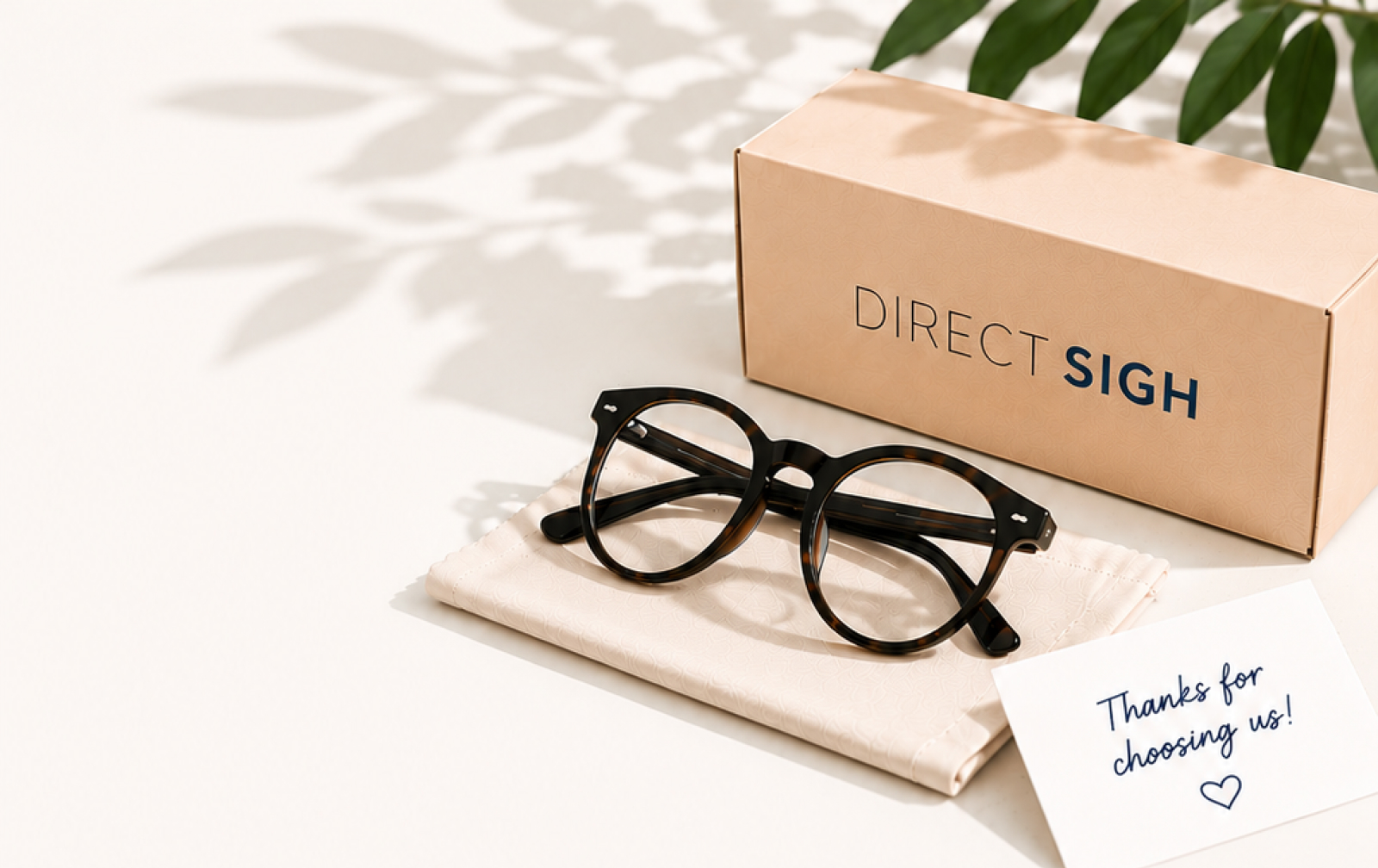Glasses sitting on a cleaning cloth next to a direct sight box