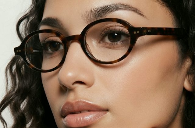 Woman wearing an oval plastic tortoise glasses frame
