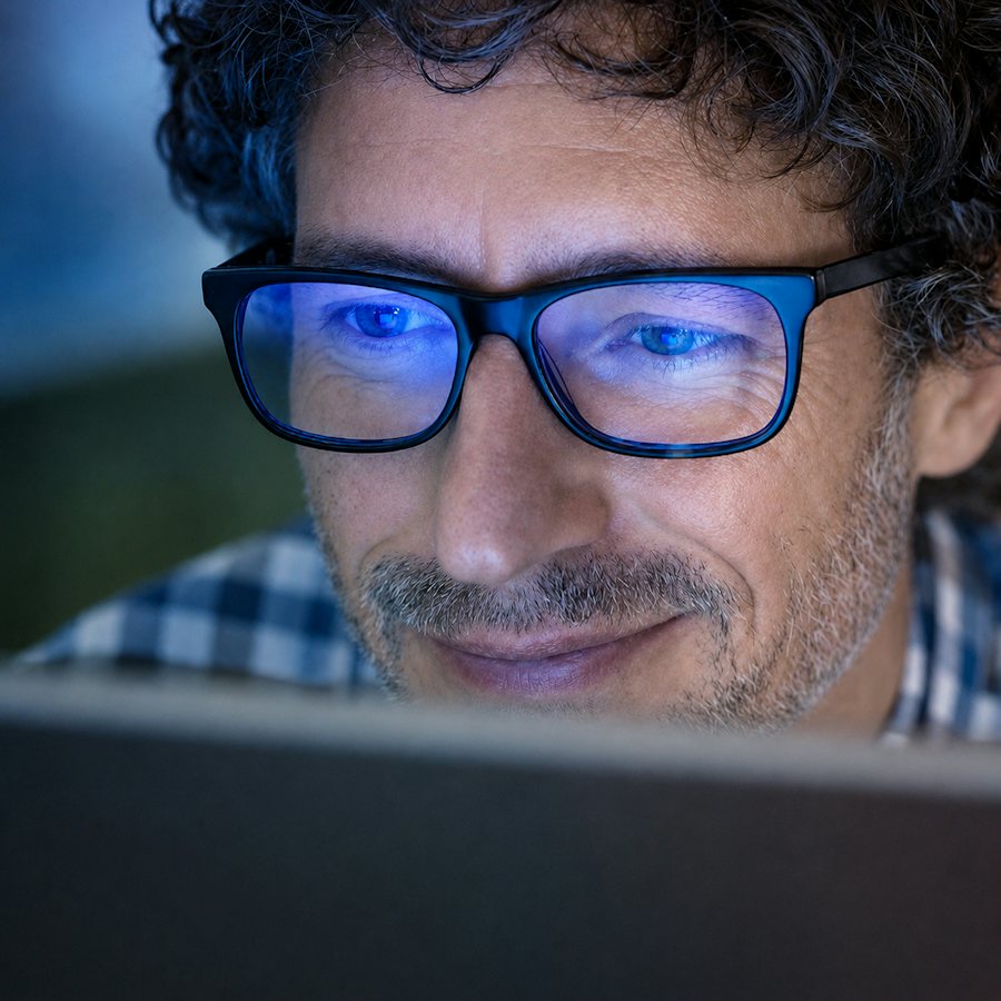 Man wearing blue light blocking glasses