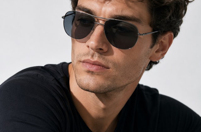man wearing aviator style gun metal sunglasses with grey lenses