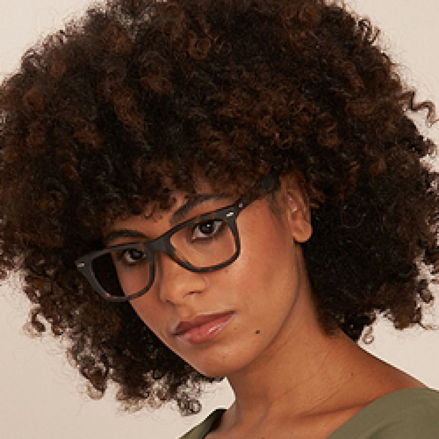 Woman wearing wayfarer style plastic glasses frame