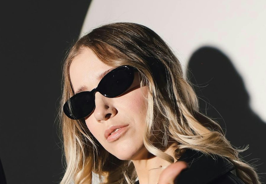 Stylish woman wearing oval shaped black sunglasses