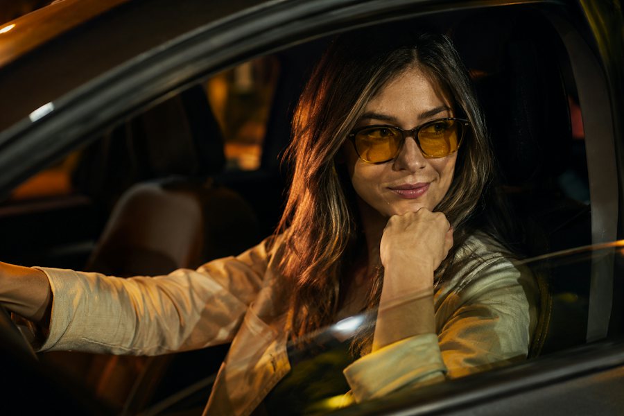 Woman driving at night wearing glasses with yellow tinted lenses