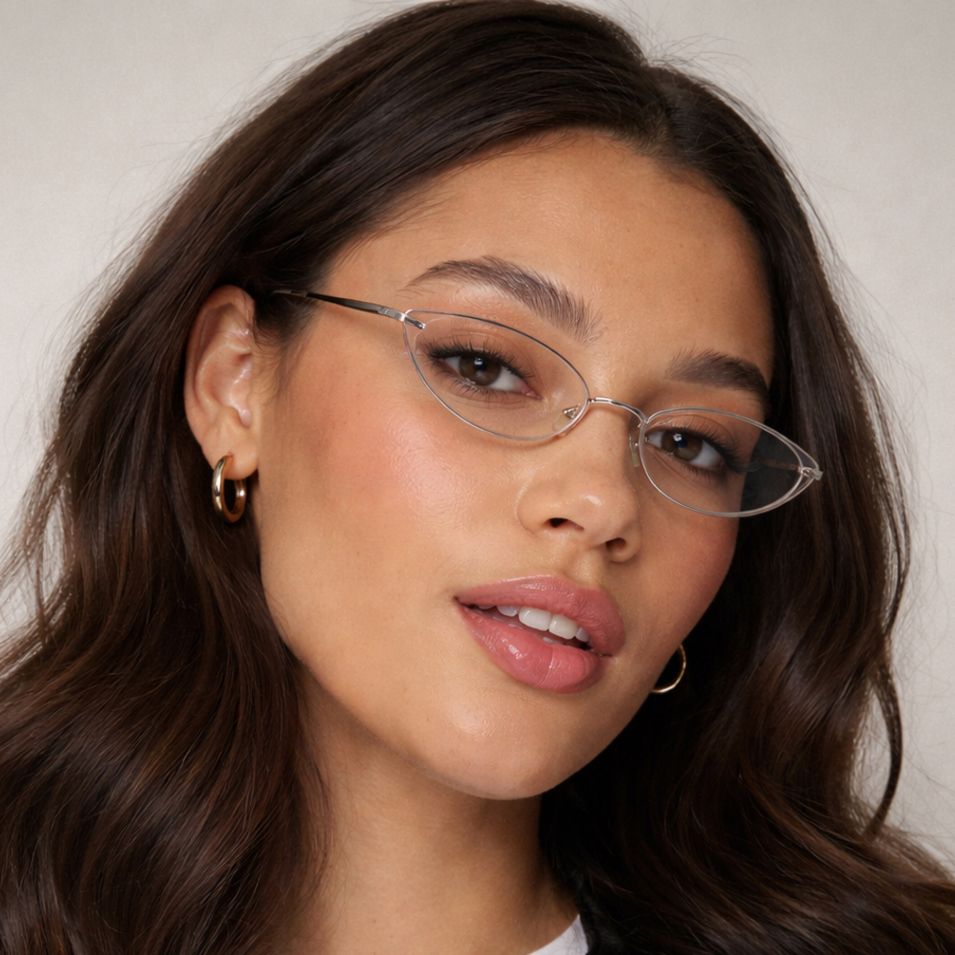 Woman wearing a rimless minimal cat eye shaped frame