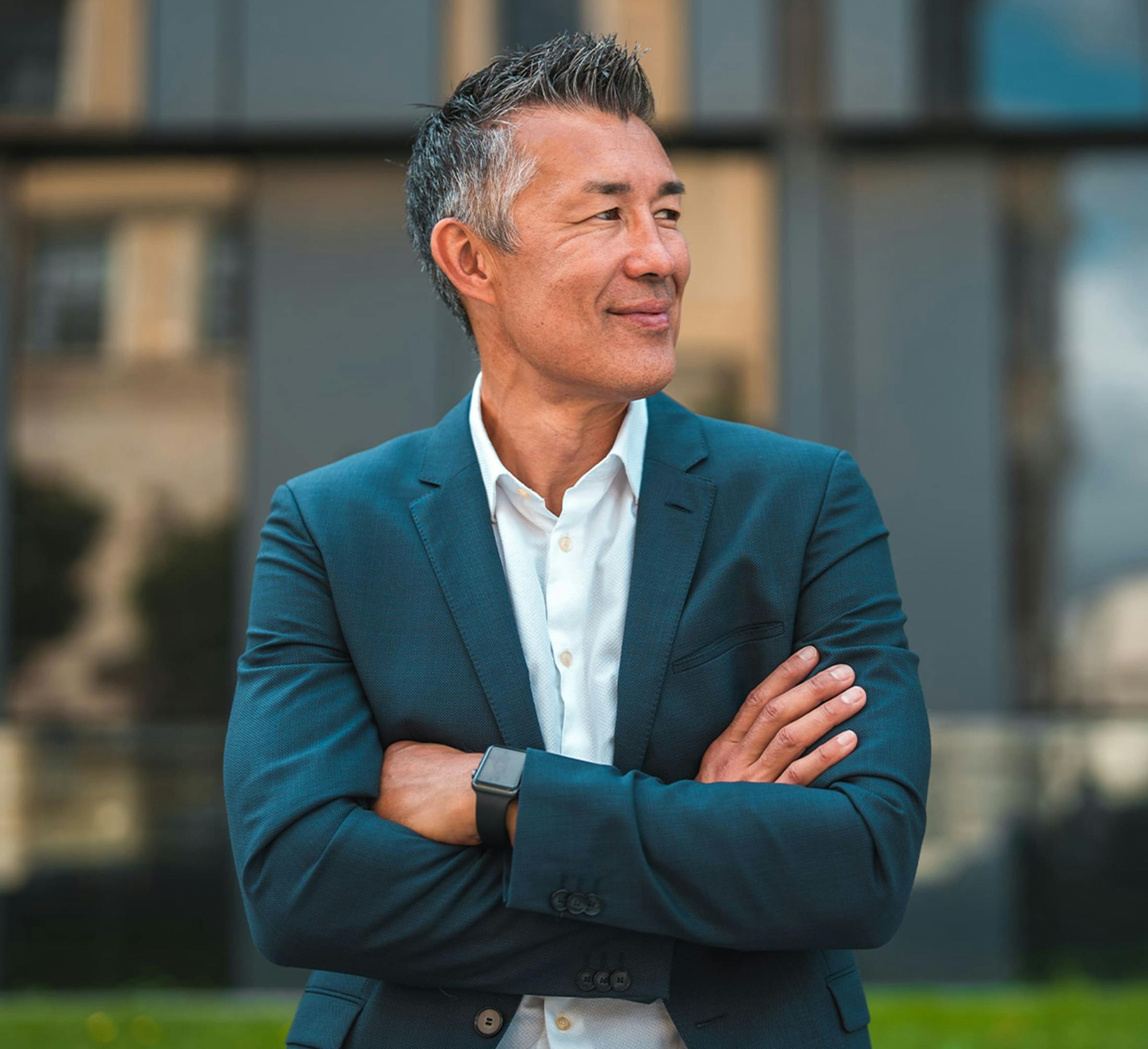 man in blue suit crossing his arms