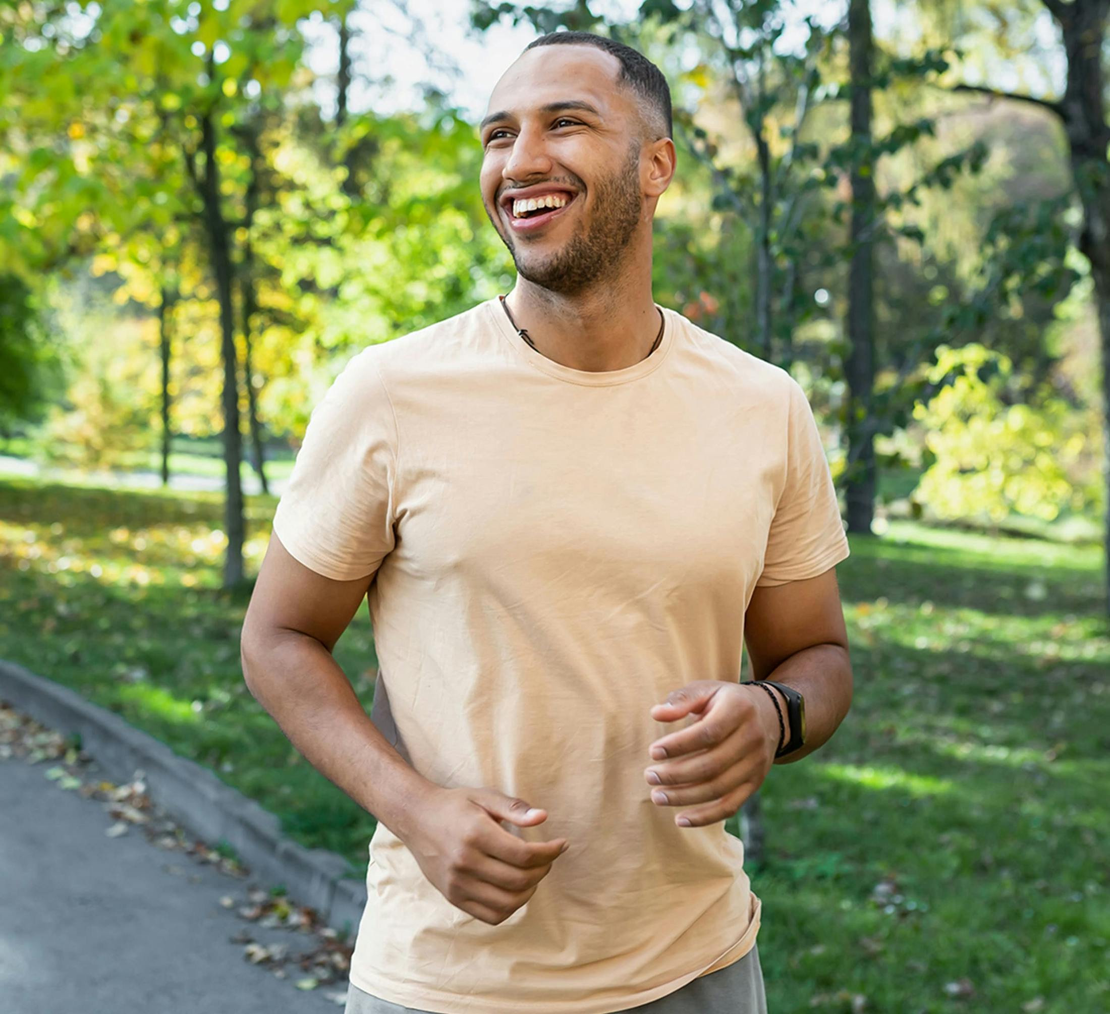 man smiling while jogging outside