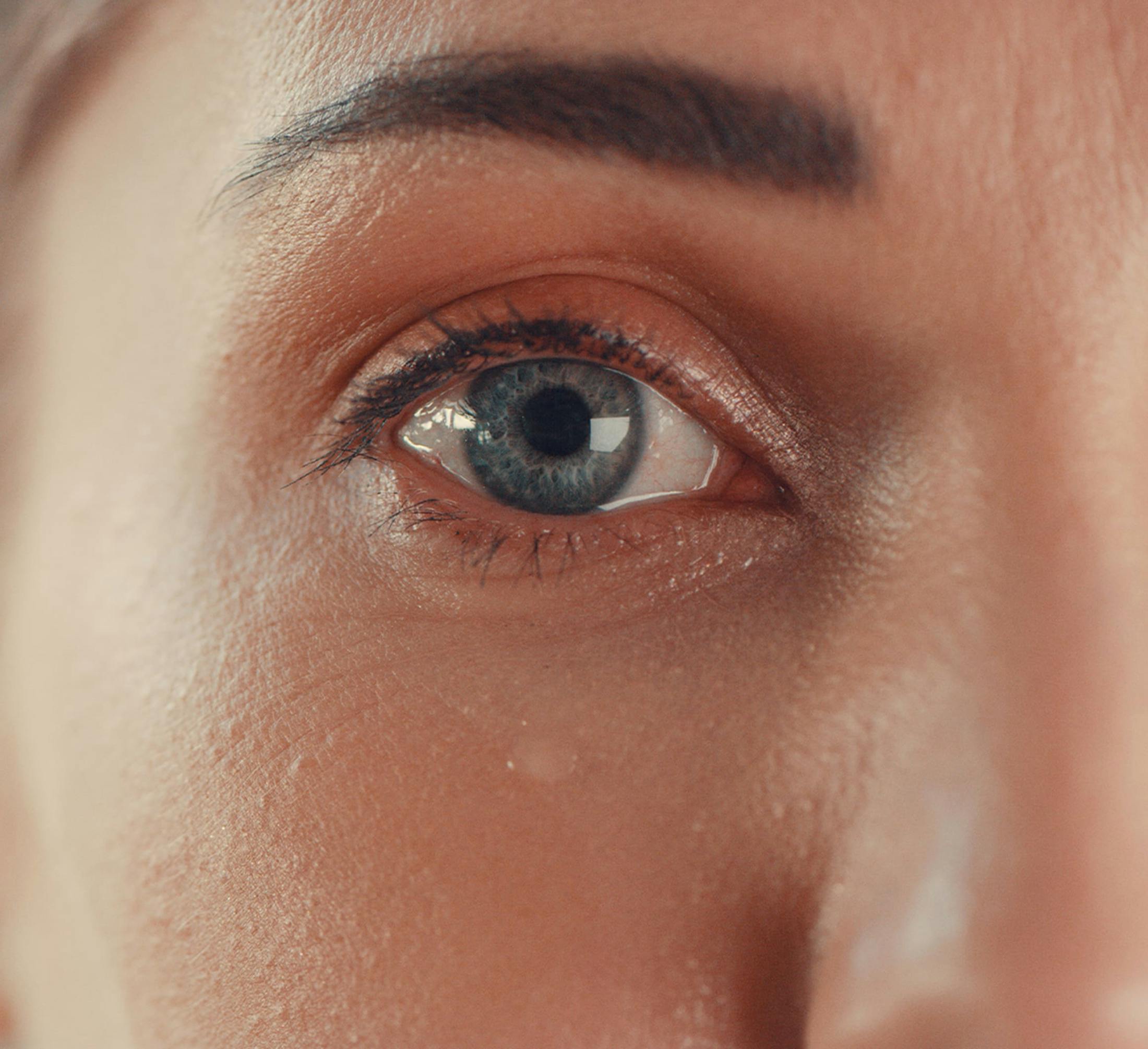 close up on woman's eye crying