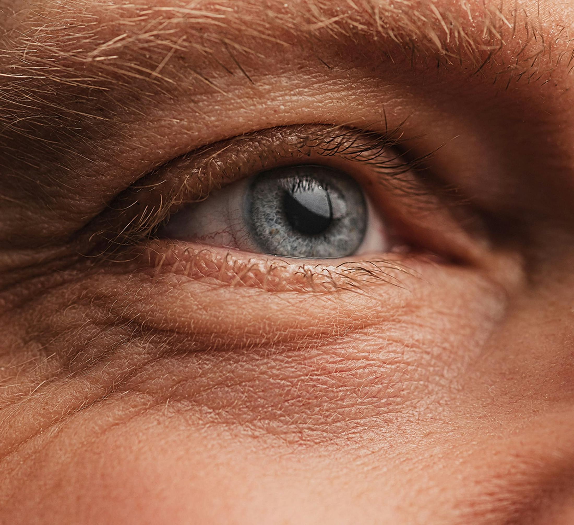 close up on older person's blue eye