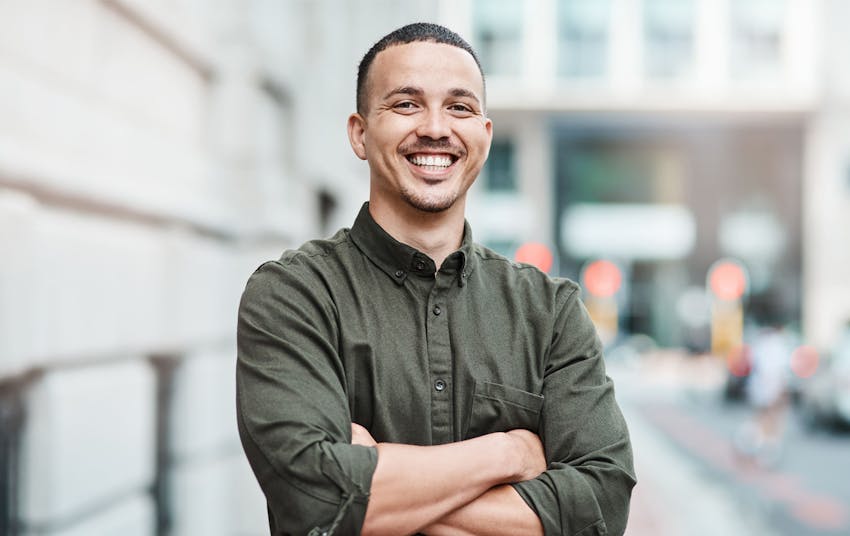 Man with arms crossed smiling