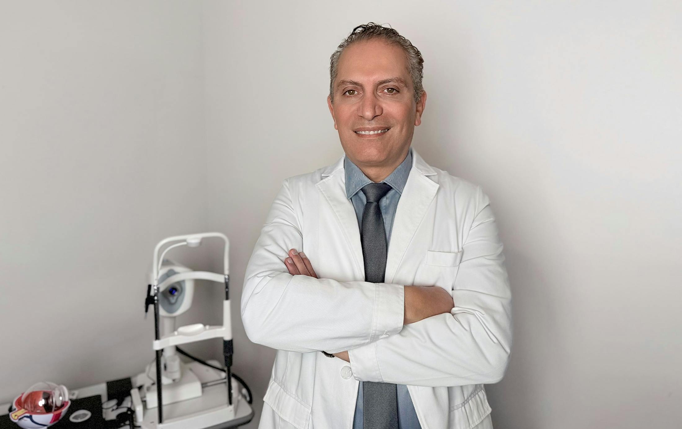 Dr. Cohen smiling in his professional attire