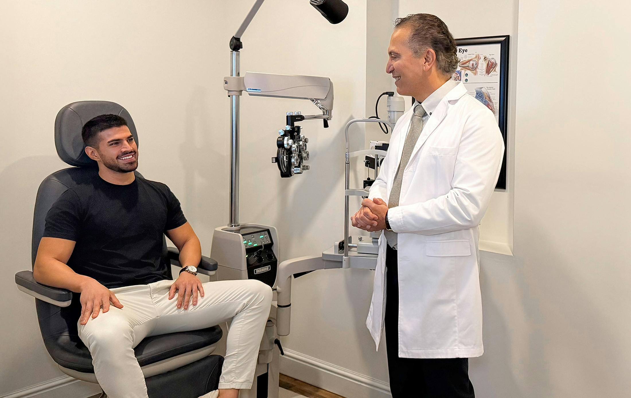 Dr. Cohen speaking with patient while he sits in exam chair