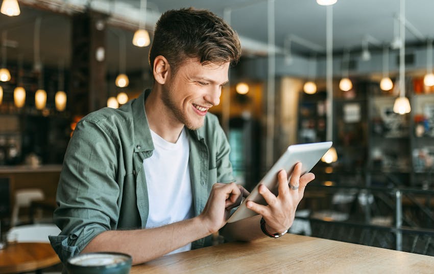 man smiling on ipad