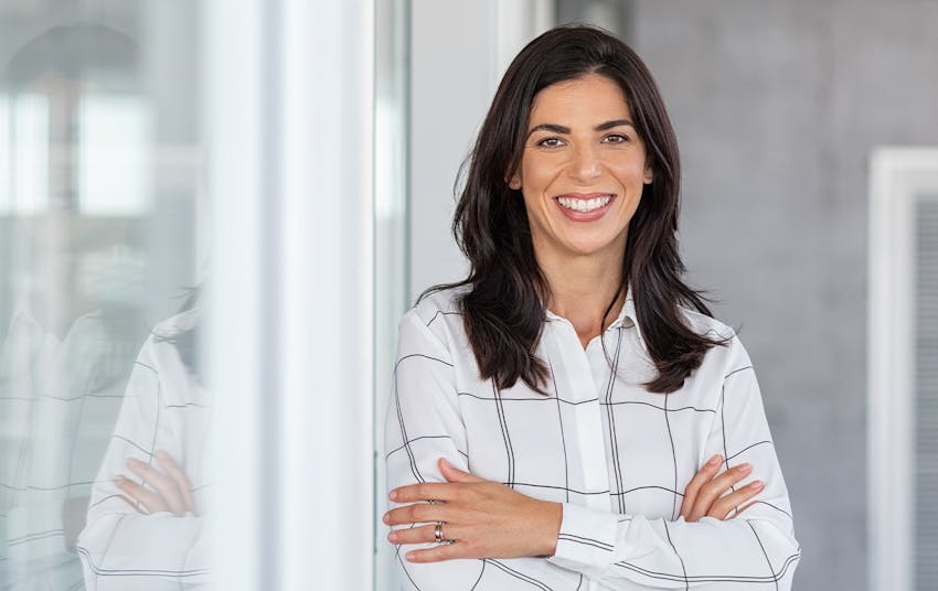 woman smiling with her arms crossed