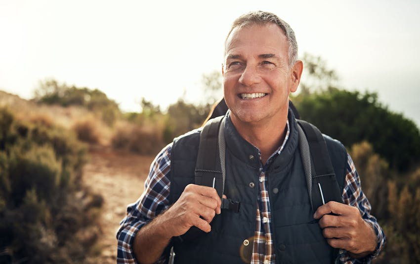 Man smiling while wearing a backback