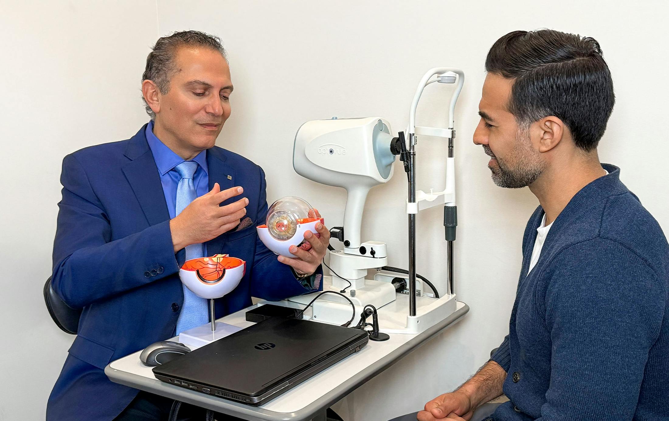 Dr. Cohen showing eye example to male client