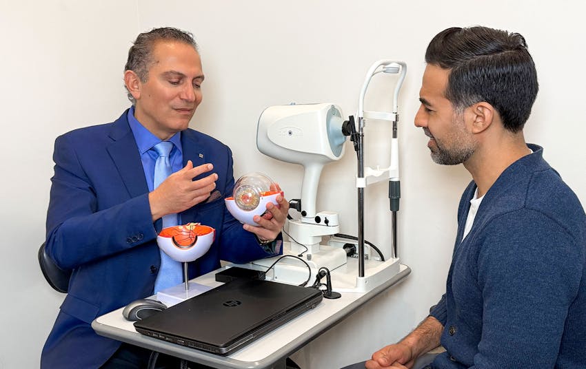 Dr. Cohen showing eye example to male client