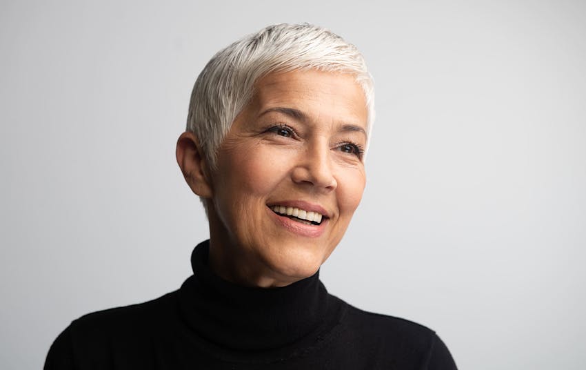 older woman with short grey hair smiling