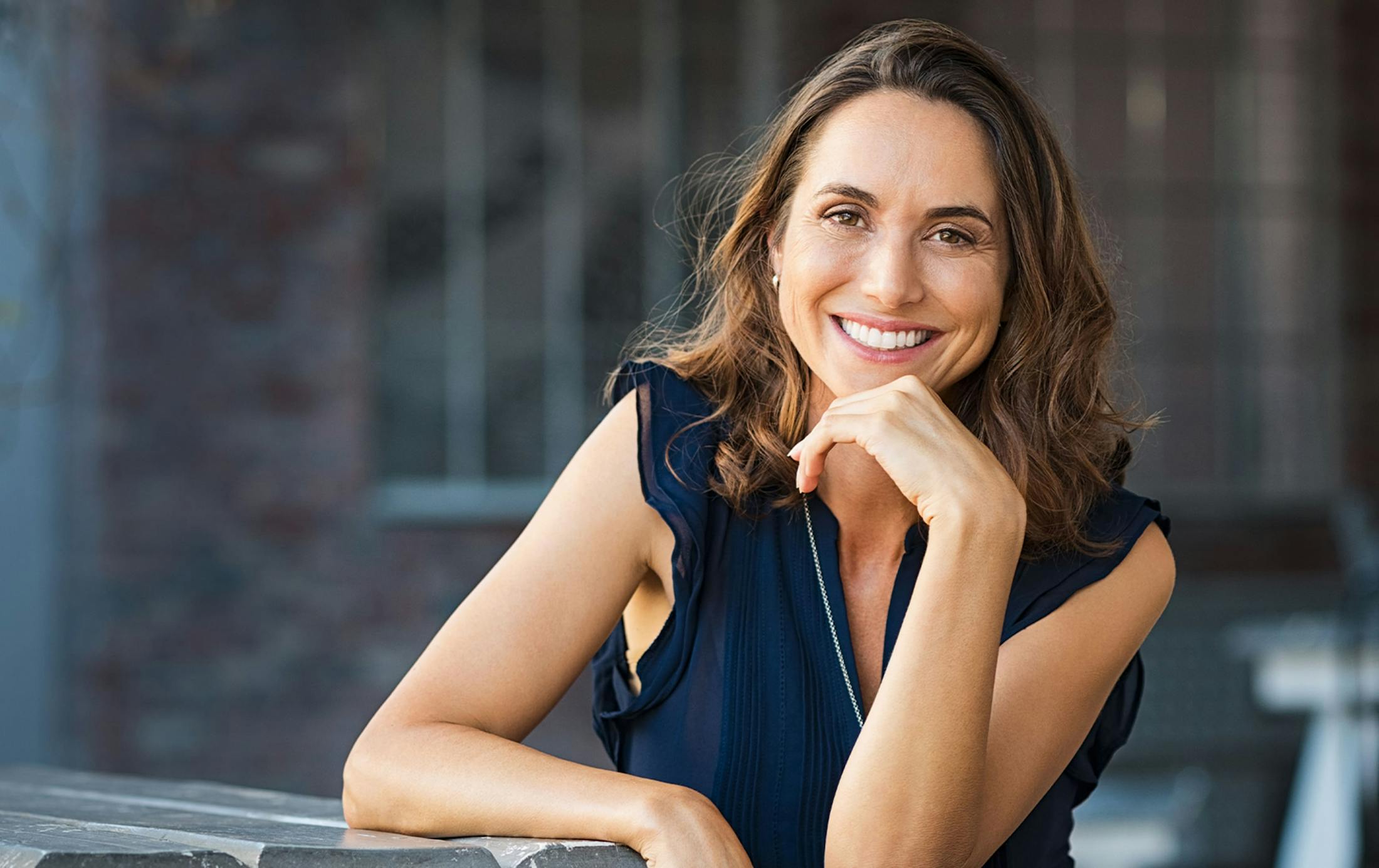 Woman smiling sitting at a table