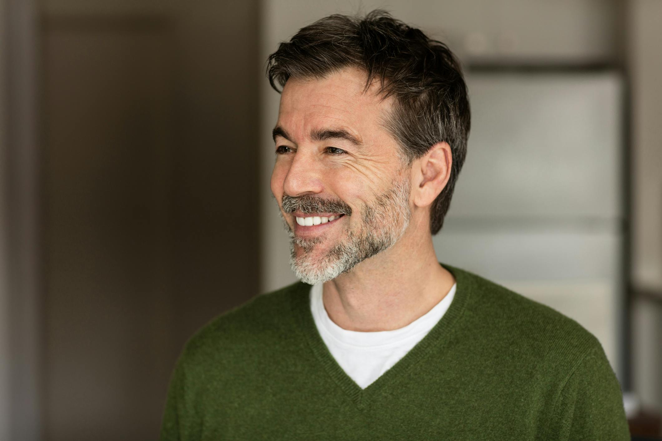 middle aged man in a green sweater